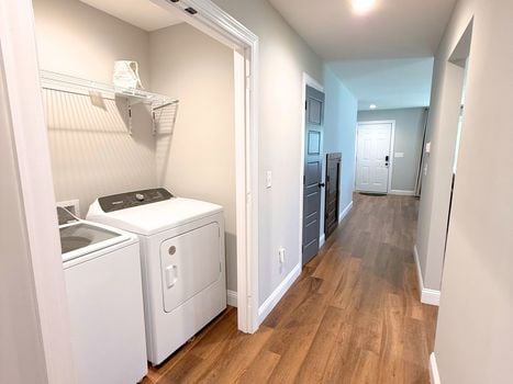 Dedicated laundry area conveniently located inside the home with built-in shelving for additional storage.