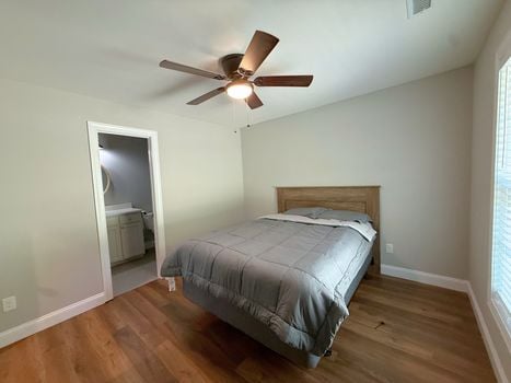 Comfortable primary bedroom with generous floor space, neutral finishes, and abundant natural light.