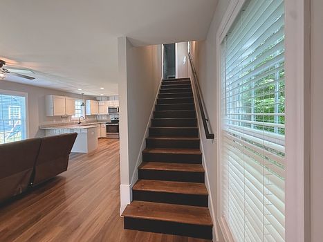 Interior staircase with luxury vinyl plank flooring in Chester South Carolina home.