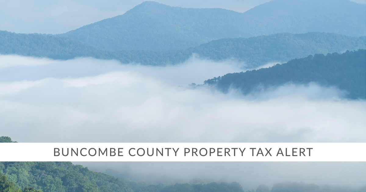 A picture of the Blue Ridge Mountains with a banner that reads Buncombe County Property Tax Alert in capital letters