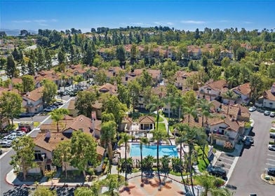 Palm Court at Laguna Heights townhomes with resort-style pool and tennis amenities