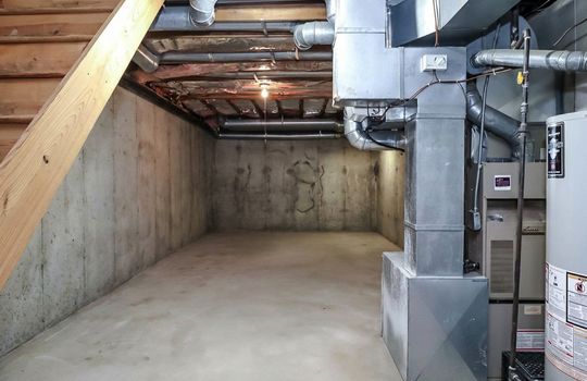 Additional basement storage area providing ample space for seasonal items, tools, and household organization