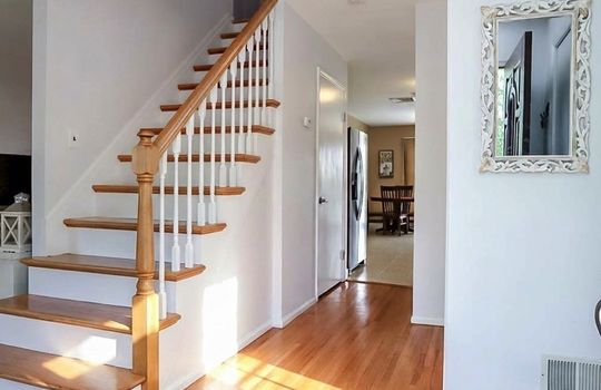 Bright entry hall with hardwood floors, classic staircase, and an open flow to the main living areas in this Tottenville Staten Island home.