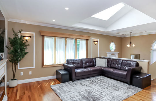 Custom living room with decorative woodwork and natural light in Prince's Bay Staten Island ranch