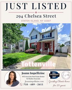 Front exterior of 294 Chelsea Street, a four-bedroom Colonial home for sale in Tottenville Staten Island with covered front porch and private driveway.