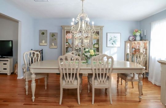 Spacious formal dining room featuring gleaming hardwood floors, oversized windows, and timeless charm in this Tottenville Staten Island home.