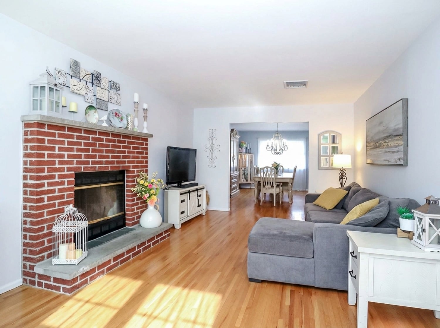 Living room with hardwood floors and brick fireplace at 294 Chelsea Street