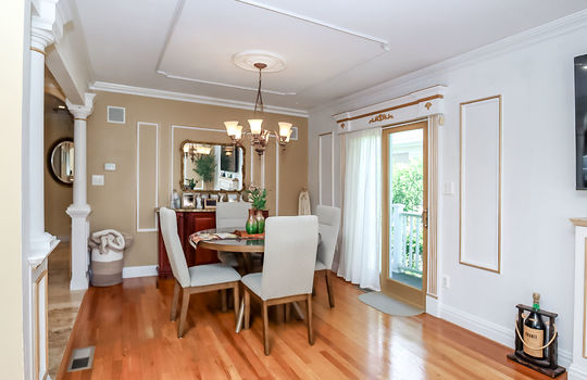 Sunny dining room with hardwood floors and sliders to deck