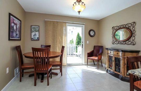 Sunny eat-in dining area with sliding glass doors leading to the deck, creating the perfect space for everyday meals and indoor-outdoor entertaining.