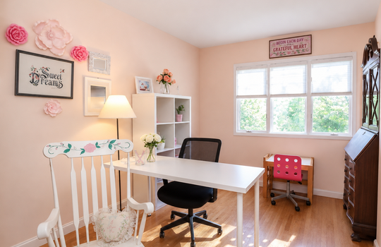 Sunny front bedroom with hardwood floors