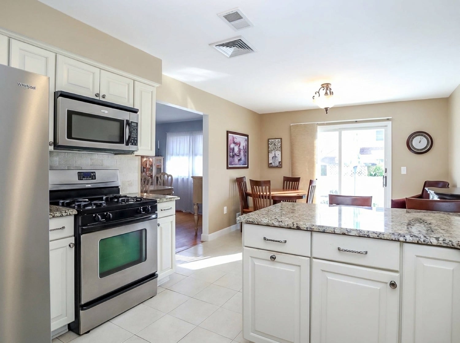 Updated eat-in kitchen with granite countertops and stainless steel appliances at 294 Chelsea Street