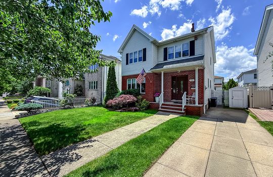 Well-maintained colonial home with charming front porch, private driveway, and attractive landscaping in the sought-after Tottenville neighborhood of Staten Island.