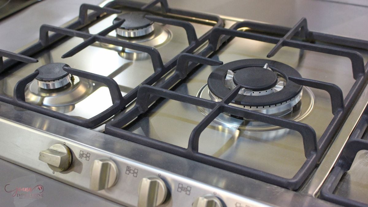 Checking a gas stove during a buyer final walk-through before closing