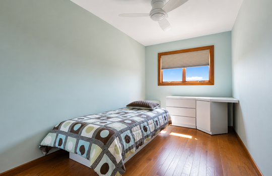 Second bedroom with hardwood floors and natural light in three-bedroom Grasmere condo