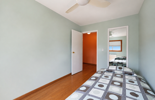 Second bedroom with hardwood floors and natural light in three-bedroom Grasmere condo