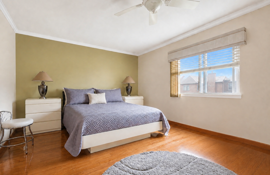 Primary bedroom with hardwood floors and generous closet space in Grasmere condo