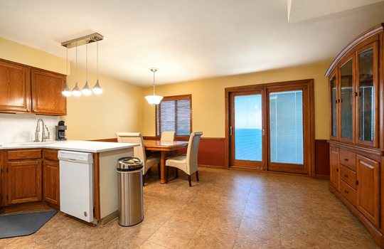 Stonegate condo kitchen with ample cabinetry and counter space slider to balconyin Grasmere Staten Island