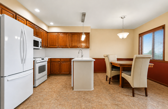 Updated kitchen with wood cabinetry and stainless steel appliances in Grasmere condo