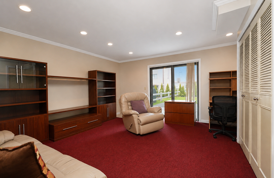 Family room with built-in storage and sliding glass door to outdoor area