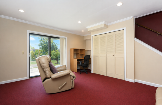Family room with built-in storage and sliding glass door to outdoor area