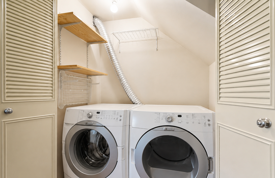 In-unit laundry area with washer and dryer in Stonegate condo