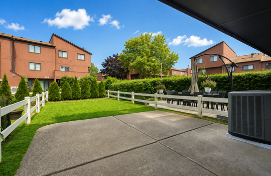 Open lawn and patio area behind Stonegate condo in Grasmere Staten Island