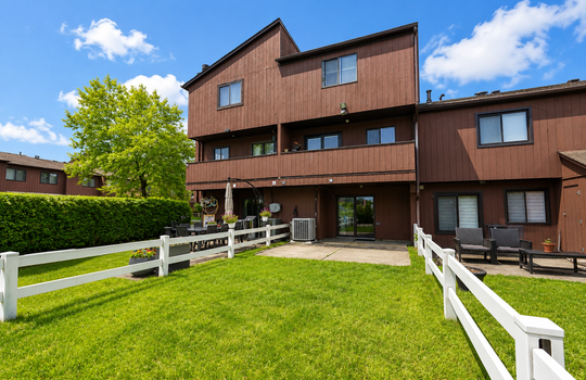 Open lawn and patio area behind Stonegate condo in Grasmere Staten Island