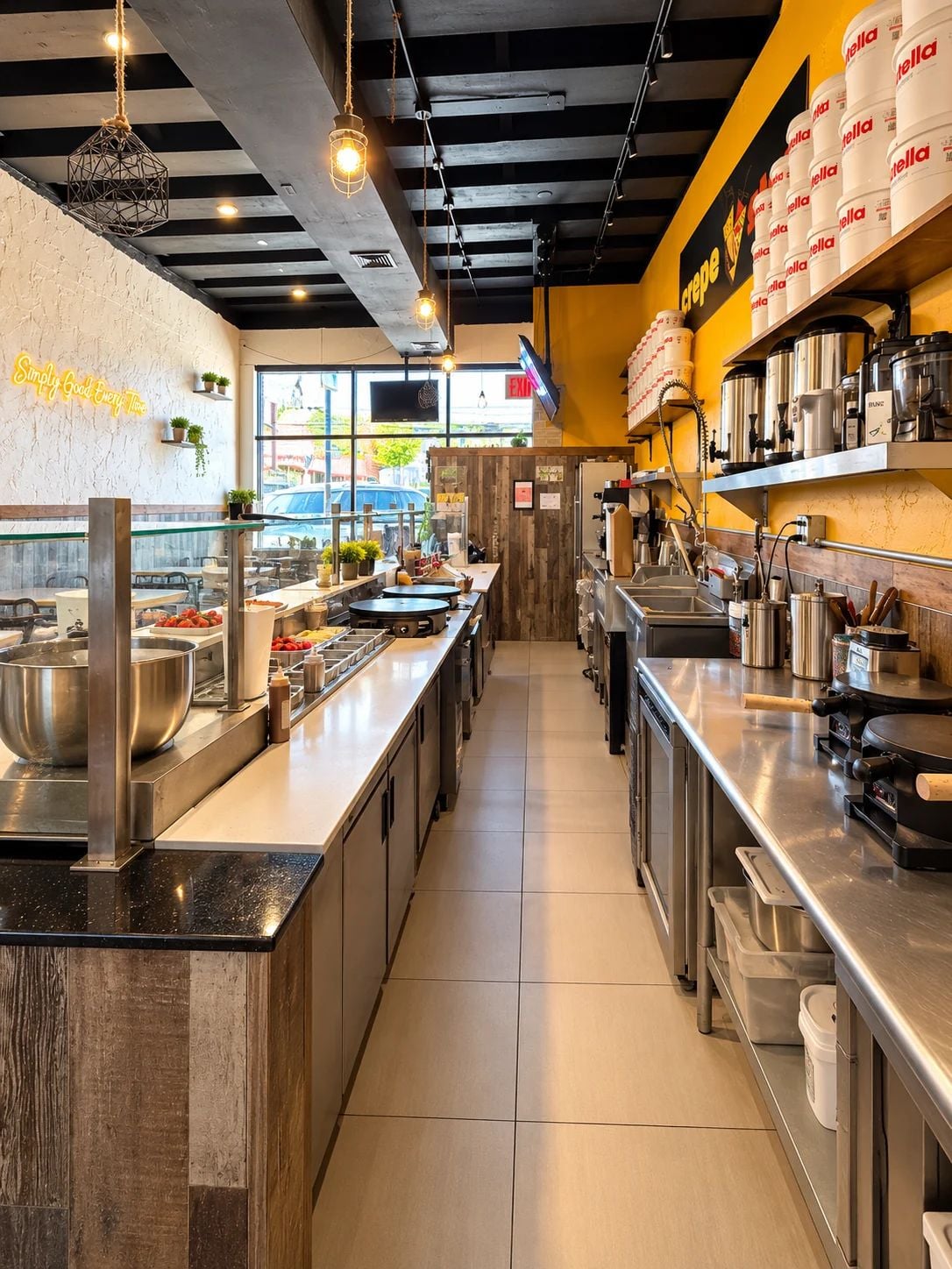 Commercial food preparation area at Crepe Stop with stainless steel counters and crepe equipment