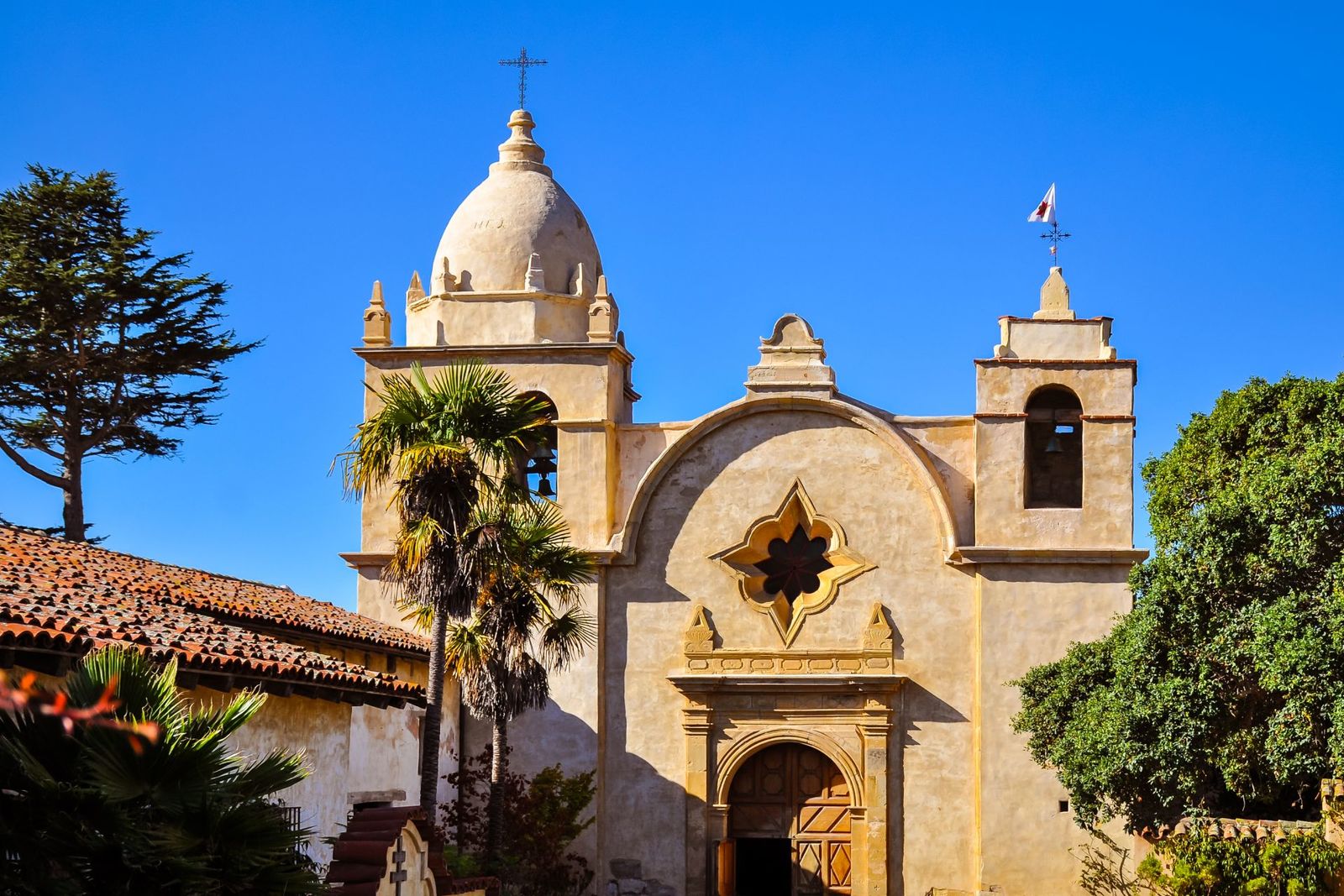 The Carmel Mission Basilica under a clear blue sky
