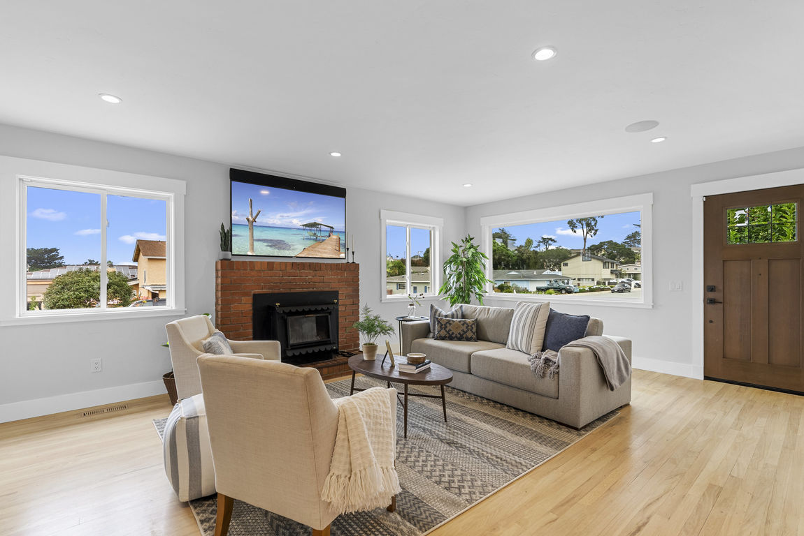 Staged living room with a brick fireplace at 1149 Modoc Street, Seaside