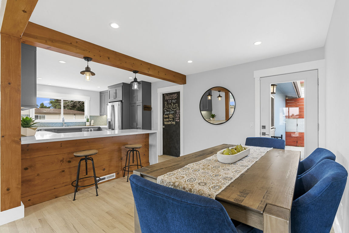Dining area and kitchen with a waterfall-edge peninsula at 1149 Modoc Street, Seaside