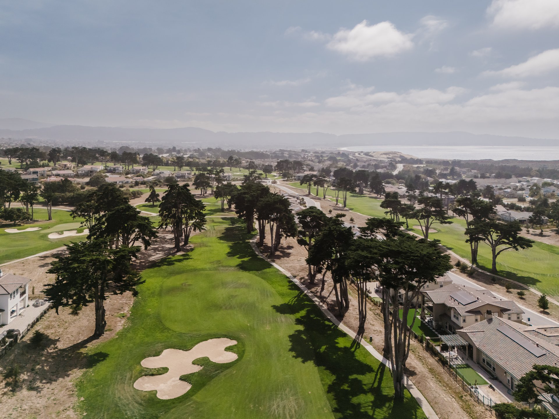 Aerial view of Bayonet and Black Horse golf courses with homes and Monterey Bay beyond