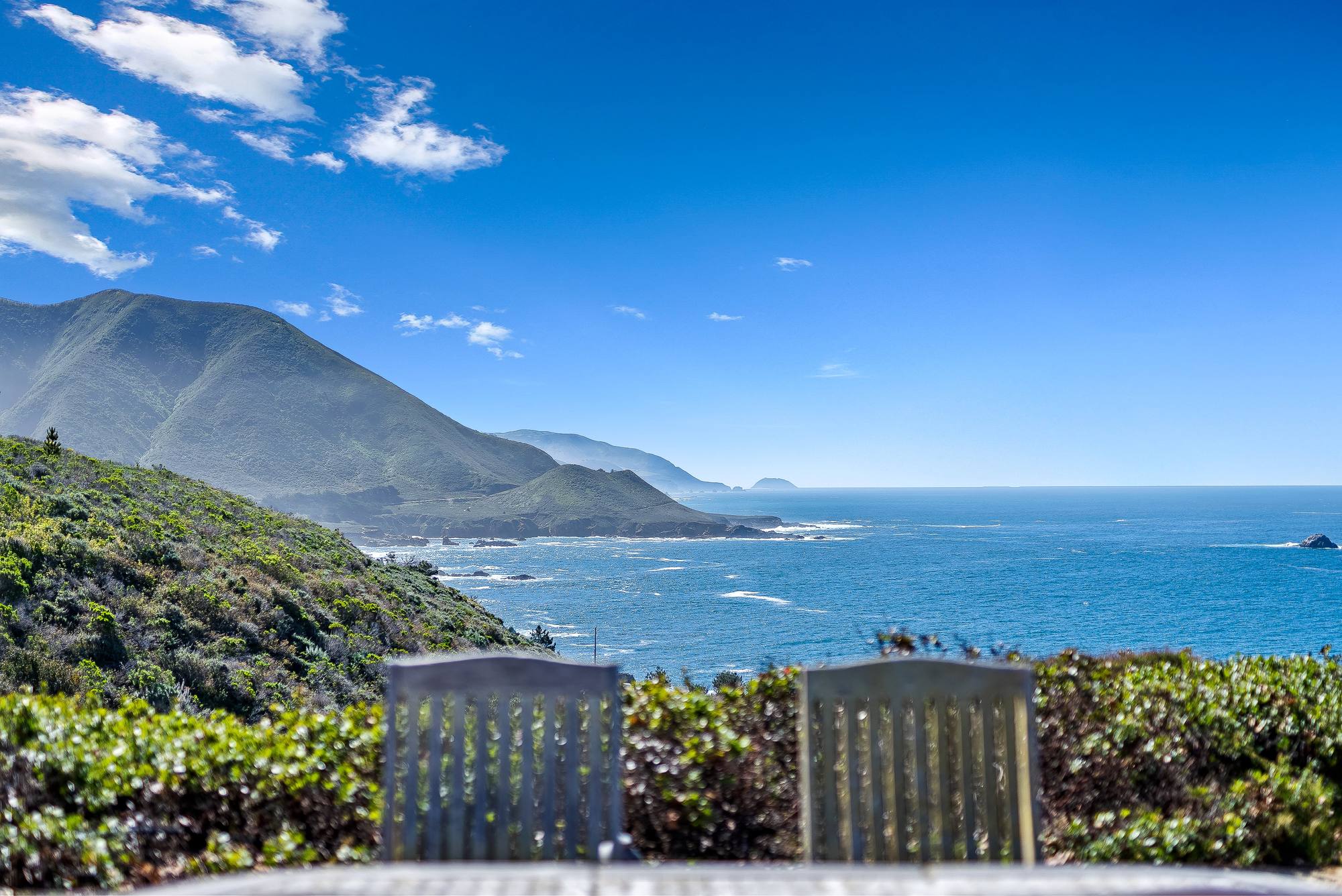 Two chairs facing the Big Sur coastline