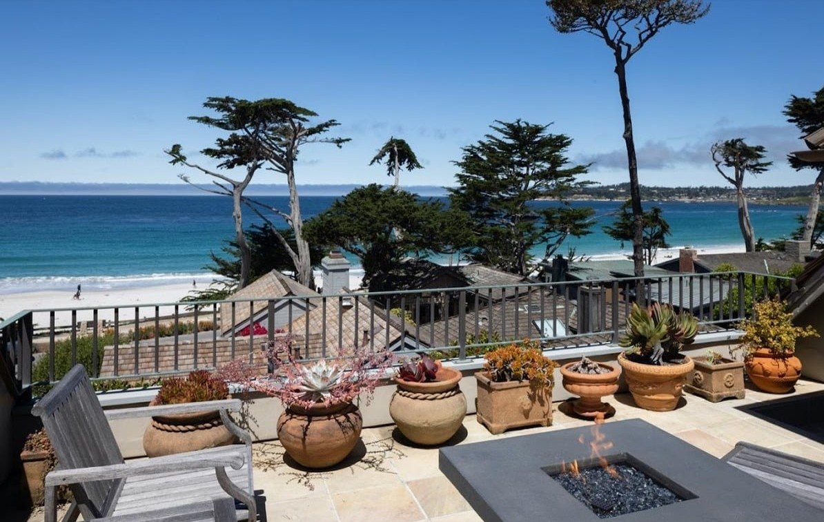 Ocean-view roof terrace with a fire table and potted succulents at San Antonio 2 SW of 10th, above Carmel Beach