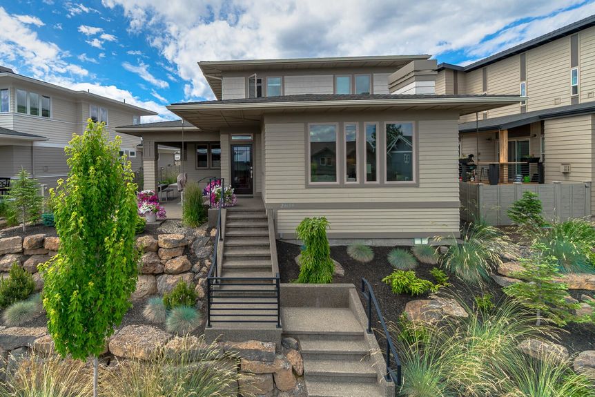 Front facade of Bend Oregon home with clear blue skies 20659 Cougar Peak Rd