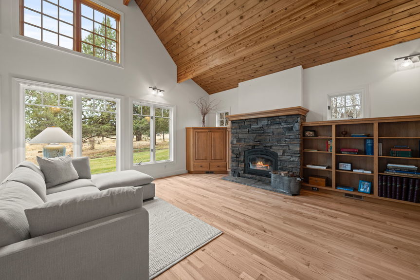 Charming wood-burning fireplace as the centerpiece of the living area at 16045 Fox Ridge Circle, perfect for cozy nights in
