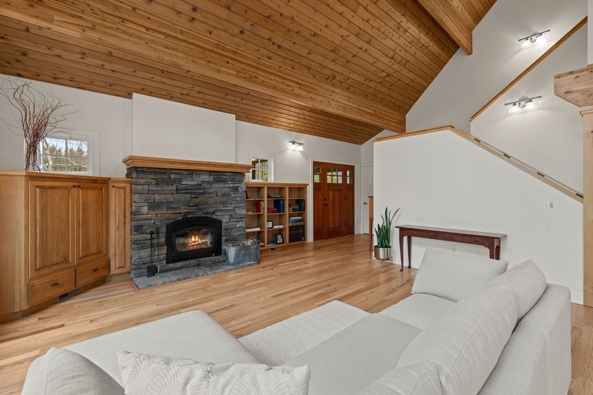 Charming wood-burning fireplace as the centerpiece of the living area at 16045 Fox Ridge Circle, perfect for cozy nights in