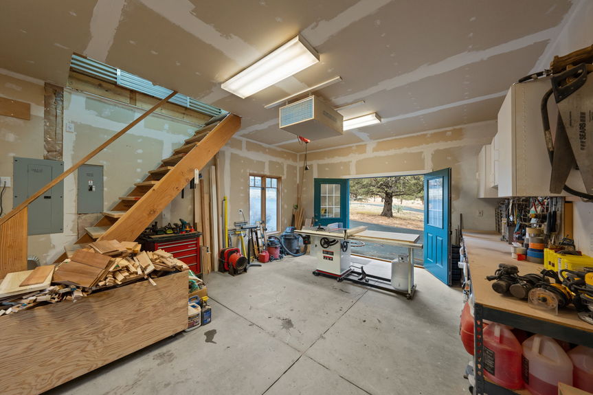 Heated workshop with artist loft and custom cabinetry, ideal for creative projects or a home office at 16045 Fox Ridge Circle, Sisters Oregon