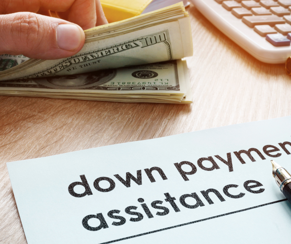 Close-up of cash and a document labeled down payment assistance, symbolizing homebuyer financial help