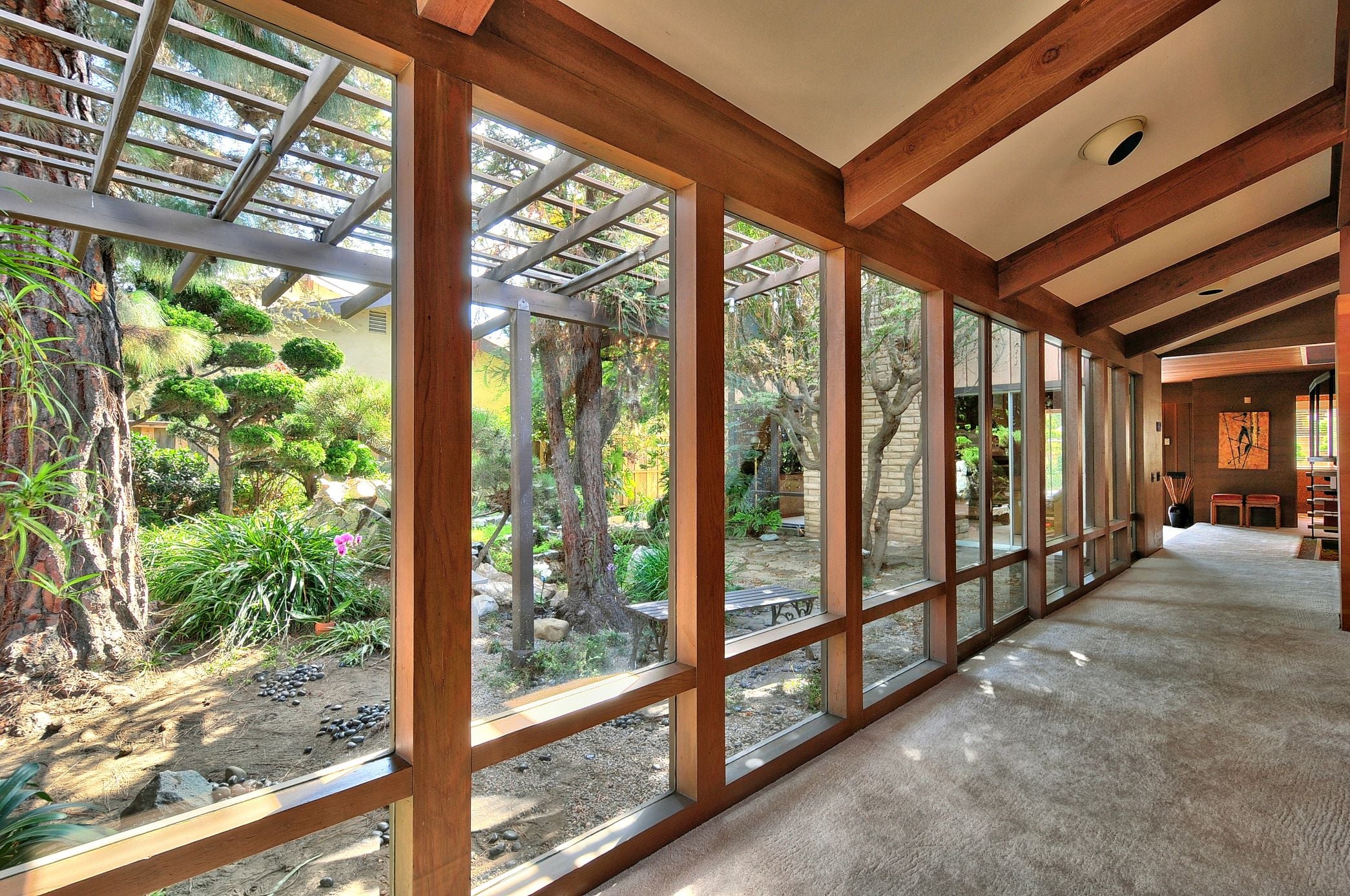 Betty Fernandez, Oxnard REALTOR® with eXp Realty, staged this Frank Lloyd Wright inspired home's Japanese zen garden with orchids, a painted bench, and cleaned floor-to-ceiling windows — helping sell an expired listing in 9 days for $65,000 more than the previous offer.