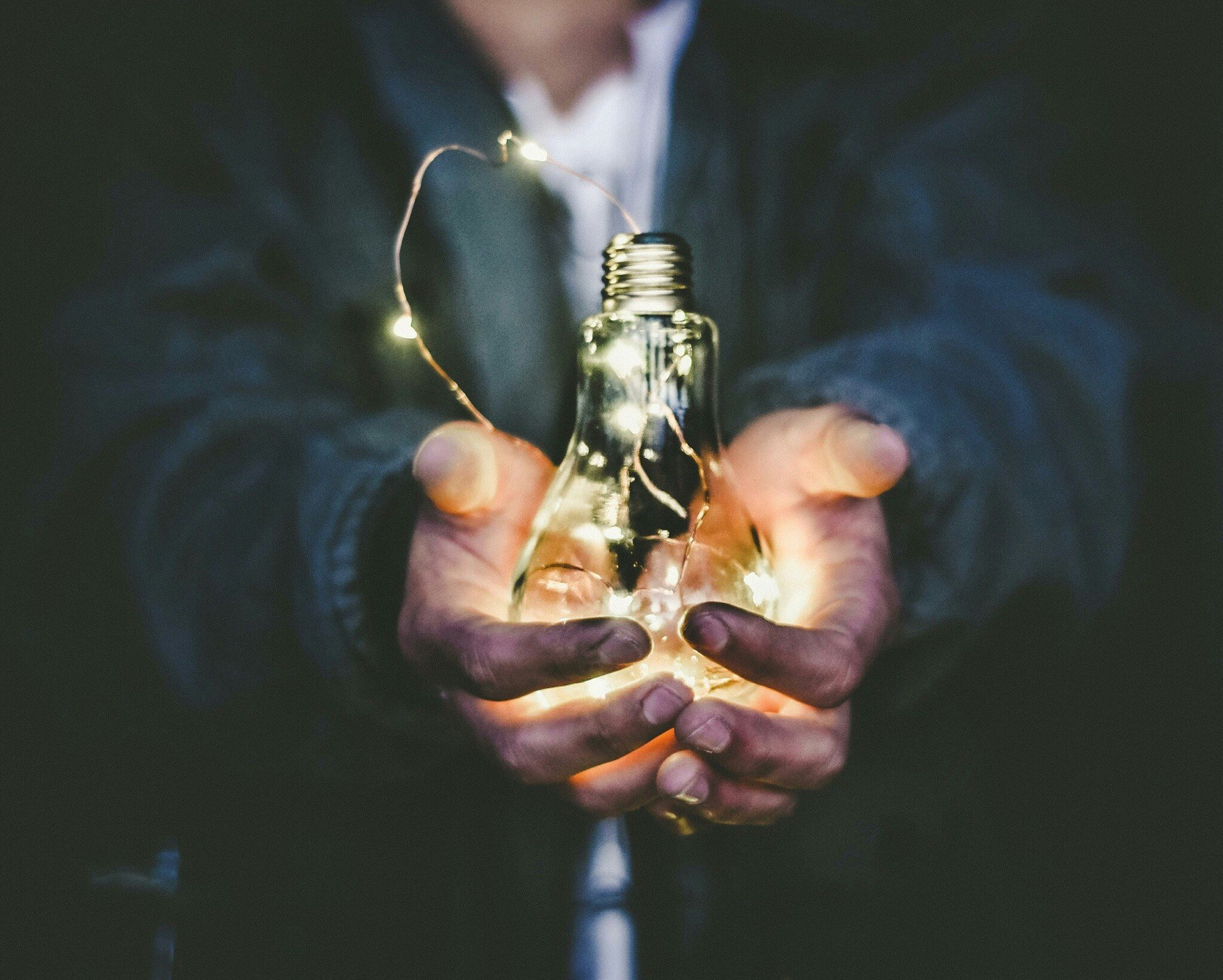 A man holding a light bulb