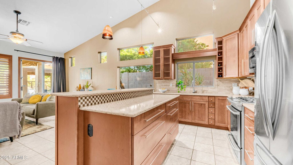 Upgraded gourmet kitchen with quartz countertops, stainless appliances and large island — Las Sendas Mesa AZ home