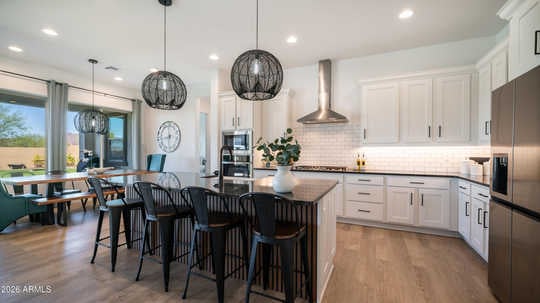 Luxury living room and upgraded kitchen in Mesa AZ Reserve at Red Rock home