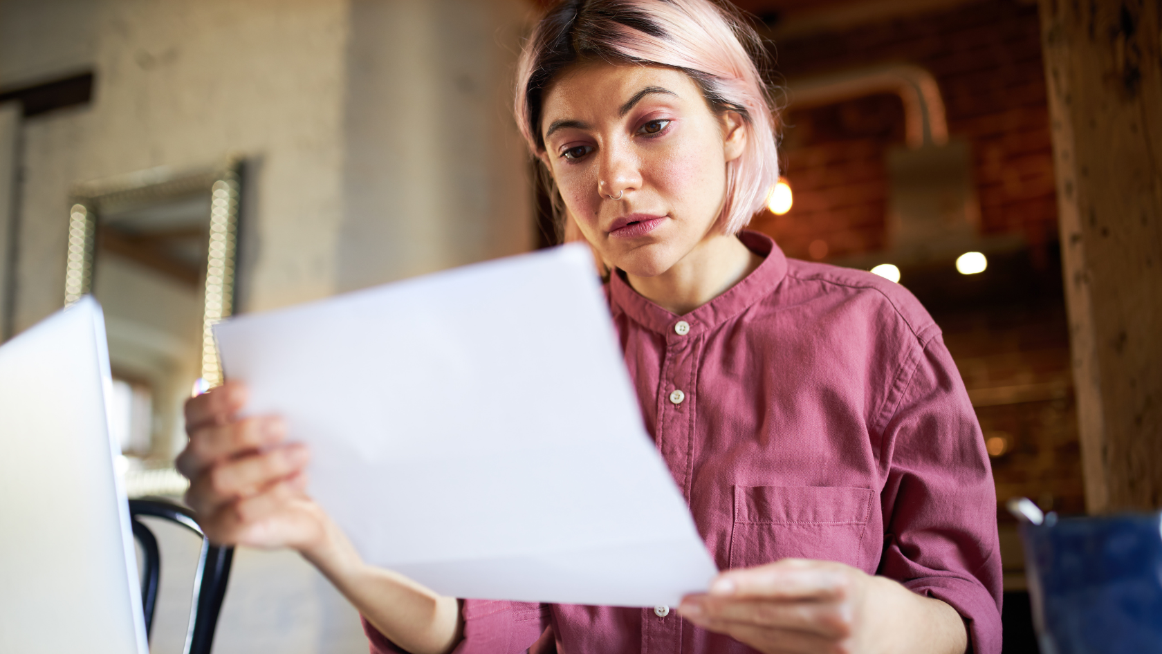 Photo: A woman reading a paper