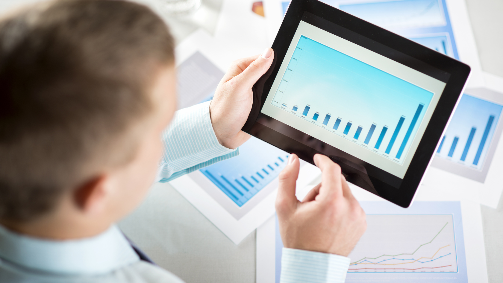 Photo: A man looking at graphics on his tablet