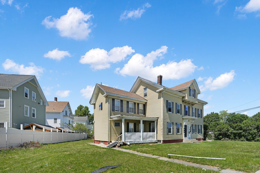 Side exterior and porch at 62 Conant St, Pawtucket, listed by Alexander Parmenidez, Coldwell Banker Realty.