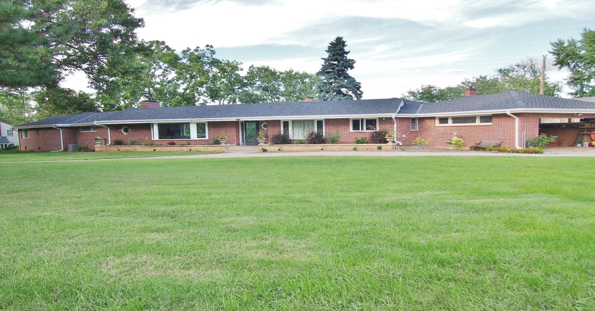 Well-maintained front lawn and landscaping at Omaha brick ranch home