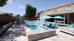 arizona hot tub and pool with travertine decking