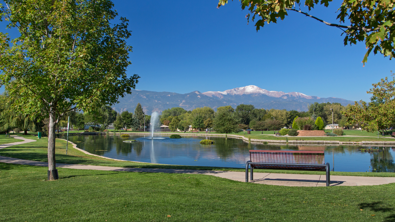 pond with trees and Pikes Peak view