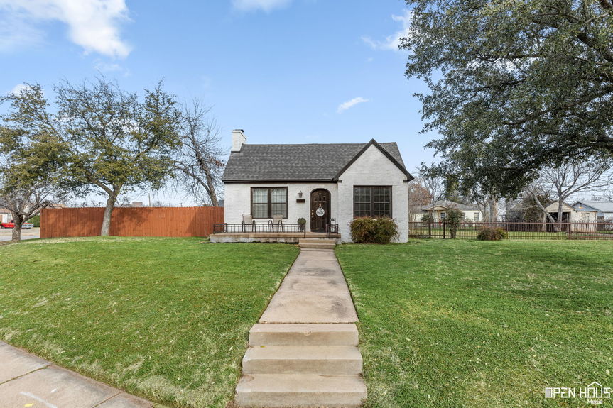 White 1930s corner home with new roof and windows at 2234 Harrell St, Wichita Falls, TX.